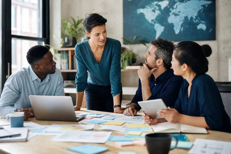A global small-business team collaborating in a modern workspace